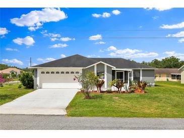 Charming single-story home featuring a two-car garage, well-maintained lawn and inviting curb appeal at 845 Valnera Ct, Kissimmee, FL 34758