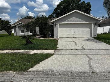 Charming single-Gathering home features a well-maintained lawn and a two-car garage, complete with an ADT security system at 10712 Fairhaven Way, Orlando, FL 32825