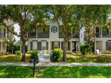 Charming two-story home with a walkway leading to the front door and mature trees in the front yard at 1615 Wilson Ave, Orlando, FL 32804