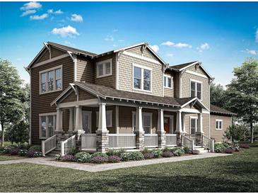 Charming two-story home with inviting front porch, columns, and lush landscaping at 1878 Seawall Way, Celebration, FL 34747