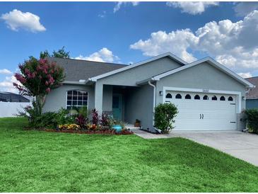 Charming single-story home with a well-manicured lawn and beautiful landscaping at 2650 Autumn Creek Cir, Kissimmee, FL 34747