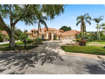 Stunning exterior showcasing a well-manicured lawn, terracotta roof, palm trees, and a circular driveway at 1274 Prince Ct, Lake Mary, FL 32746