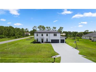 Stately two-story home with a spacious yard, complemented by a long driveway and mature trees at 20796 Quinn St, Orlando, FL 32833