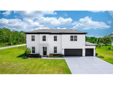 Stunning two-story home featuring a three-car garage and meticulously landscaped front yard at 20796 Quinn St, Orlando, FL 32833