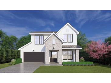 New two-story home with gray and white brick, black trim windows, gray roof, and a black two-car garage at 2215 Amherst Ave, Orlando, FL 32804