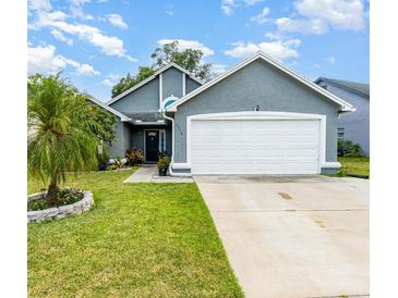 Charming home featuring a well-manicured lawn and a two-car garage at 2216 Grand Tree Ct, Lake Mary, FL 32746