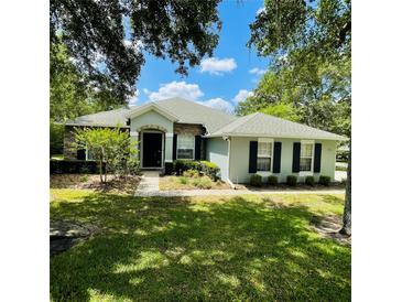 Charming single-story home featuring a manicured lawn and inviting front entrance at 2782 Cedar Knoll Dr, Apopka, FL 32712