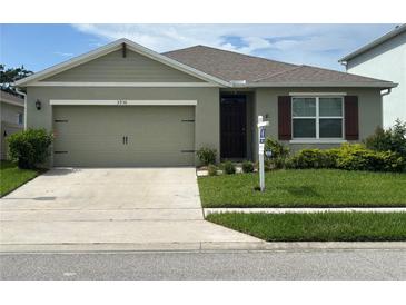 Charming single-story home featuring an attached two-car garage, manicured lawn, and beautiful exterior paint at 3936 Silverstream Ter, Sanford, FL 32771