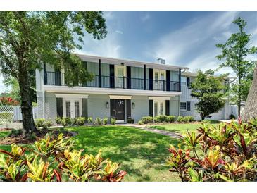 Charming two-story home featuring a lush green lawn and lovely landscaping at 503 Savona Ct, Altamonte Springs, FL 32701