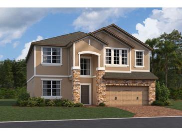 Charming two-story home with stone accents, a two-car garage, and a well-manicured lawn at 821 River Stone Trl, Sanford, FL 32771