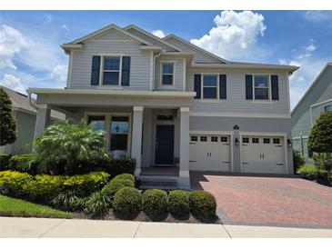 Beautiful two-story home with a landscaped front yard, attached two-car garage, and covered entryway at 9128 Sonoma Coast Dr, Winter Garden, FL 34787