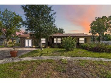 Charming home with a metal roof and beautiful landscaping at 14157 Louisville Ct, Orlando, FL 32826
