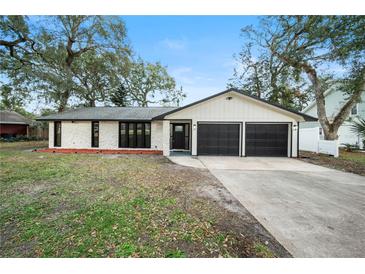 Charming renovated home with a two-car garage and a well-manicured lawn at 1523 N Beach St, Ormond Beach, FL 32174