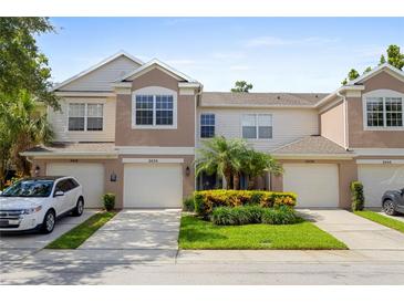 Inviting townhouse showcasing well-maintained landscaping and attached garages at 2420 Stockton Dr, Sanford, FL 32771
