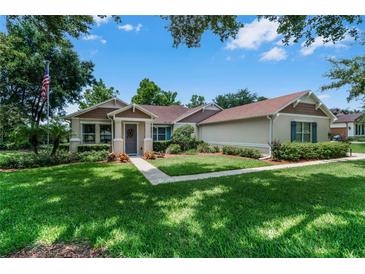 Charming single-story home featuring a well-manicured lawn, inviting walkway, and classic architectural details at 2426 Breezy Meadow Rd, Apopka, FL 32712