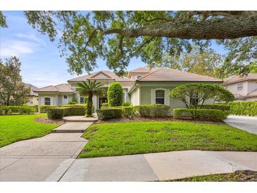 Beautiful single-story home with meticulously maintained landscaping, green grass, and mature trees at 307 Running Wind Ln, Maitland, FL 32751