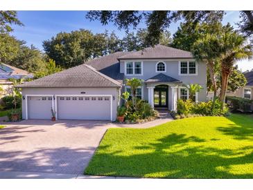 Charming two-story home featuring a three-car garage, beautiful landscaping, and a well-manicured lawn at 394 Baymoor Way, Lake Mary, FL 32746