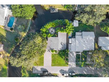 Stunning aerial view of a home with a backyard fire pit, waterfront access, a private dock, and a swimming pool at 6805 Barby Ln, Belle Isle, FL 32812