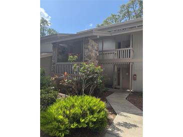 Charming two-story condo with stone accents and a well-maintained landscaped front yard at 116 Palm View Ct # 3535/6, Haines City, FL 33844