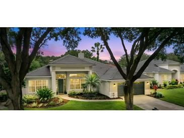 Beautiful single-Gathering home with a tile roof, well-manicured landscaping, and an attached two car garage at 387 Devon Pl, Lake Mary, FL 32746