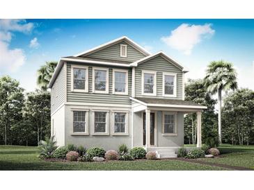 Inviting two-story home featuring a charming covered porch and lush landscaping for curb appeal at 540 Green Tracker Ave, Clermont, FL 34715