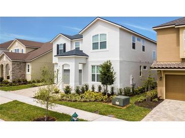Charming two-story home with landscaped yard and well-maintained lawn in a desirable neighborhood at 9071 Sunshine Ridge Loop, Kissimmee, FL 34747