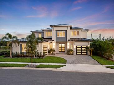 Stunning two-story home featuring a three-car garage, modern design and lush landscaping at 9156 Sheen Sound St, Orlando, FL 32836