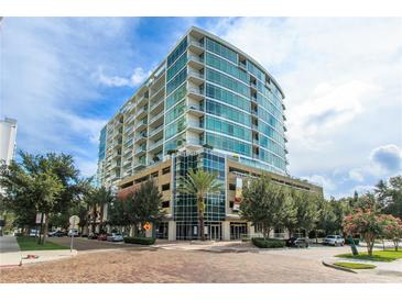 Stunning high rise with floor to ceiling glass windows and manicured landscaping at 101 S Eola Dr # 1021, Orlando, FL 32801