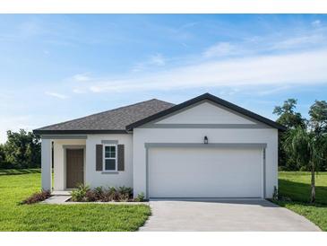 Charming one-story home featuring a two-car garage, manicured lawn, and welcoming front entrance at 1343 Dalkeith Cv, Sanford, FL 32771