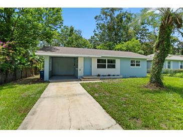 Charming single-story home with a quaint carport and lush green lawn at 167 S Sheridan Ave, Deland, FL 32720
