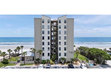 Oceanfront condo building featuring a beautiful beachfront view and well-maintained landscaping at 2121 Hill St # 7B, New Smyrna Beach, FL 32169