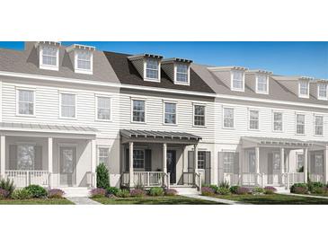 Charming new construction townhome featuring a welcoming front porch and classic architectural details at 2380 Celebration Blvd, Celebration, FL 34747