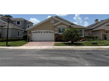 Charming single-story home with a brick driveway, two-car garage, and well-maintained landscaping at 2622 Clarinet Dr, Orlando, FL 32837