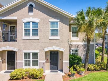 Inviting condo exterior with a stucco facade, neat landscaping, and a charming entrance at 6524 Swissco Dr # 1012, Orlando, FL 32822