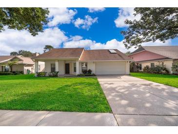 Charming single-story home with a well-manicured lawn and a two-car garage at 1017 Gould Pl, Oviedo, FL 32765