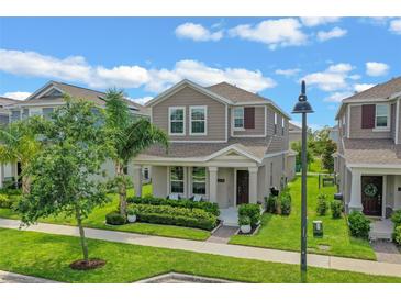 Charming two-story home with manicured lawn, landscaping, and inviting front porch at 1378 Roxy Ln, Winter Garden, FL 34787
