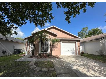Charming one-story home featuring a well-maintained lawn, attached garage, and delightful landscaping at 1470 Daniels Cove Dr, Winter Garden, FL 34787