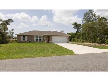 Well-maintained single-story home features a lush lawn, neutral paint, and a two-car attached garage at 16863 Sw 29Th Terrace Rd, Ocala, FL 34473