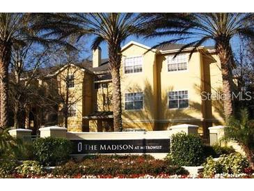 Beautiful yellow home with lush tropical landscaping at 2558 Robert Trent Jones Dr # 1435, Orlando, FL 32835