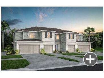 Attractive townhome featuring a two-car garage and well-maintained lawn at 3626 Raindrop Way, Sanford, FL 32773