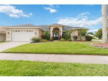 Charming single-story home boasts mature landscaping, a well-manicured lawn, and an attached two-car garage at 3808 Ocita Dr, Orlando, FL 32837