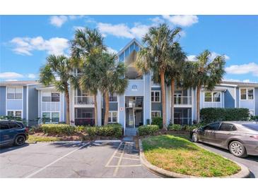 Inviting condo building with palm trees, and well-maintained landscaping at 711 Sugar Bay Way # 109, Lake Mary, FL 32746