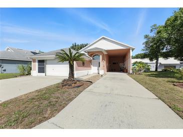 Charming single-story home with a well-maintained front yard and a spacious two-car garage at 1752 Challenger Ave, Davenport, FL 33897