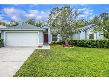 Charming one-story home featuring a two-car garage, well-maintained lawn, and mature landscaping at 10675 Fairhaven Way, Orlando, FL 32825