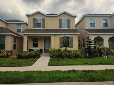 Charming two-story home with well-manicured lawn and inviting front entrance at 129 Boydfield Ln, Davenport, FL 33837