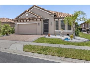 Charming single-story home with a well-maintained front yard and lush landscaping at 1709 Benoit Ter, Davenport, FL 33837