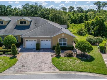 Beautiful two-story townhome with well-manicured lawn, shrubbery and brick paved driveway at 2673 Rutledge Ct, Winter Haven, FL 33884