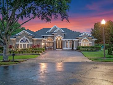 Stunning single-story home featuring a brick driveway and lush landscaping in a well-maintained community at 3619 King George Dr, Orlando, FL 32835