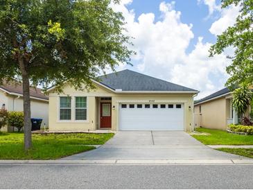 Charming single-story home with a well-manicured lawn and a two-car garage at 7557 Azalea Cove Cir, Orlando, FL 32807