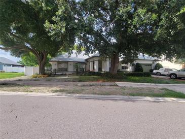 Charming home with mature trees and well-manicured landscaping at 8603 Snowfire Dr, Orlando, FL 32818